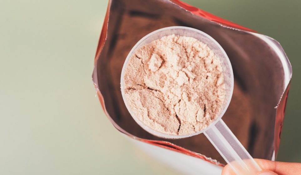 scooping a protein powder in a pack